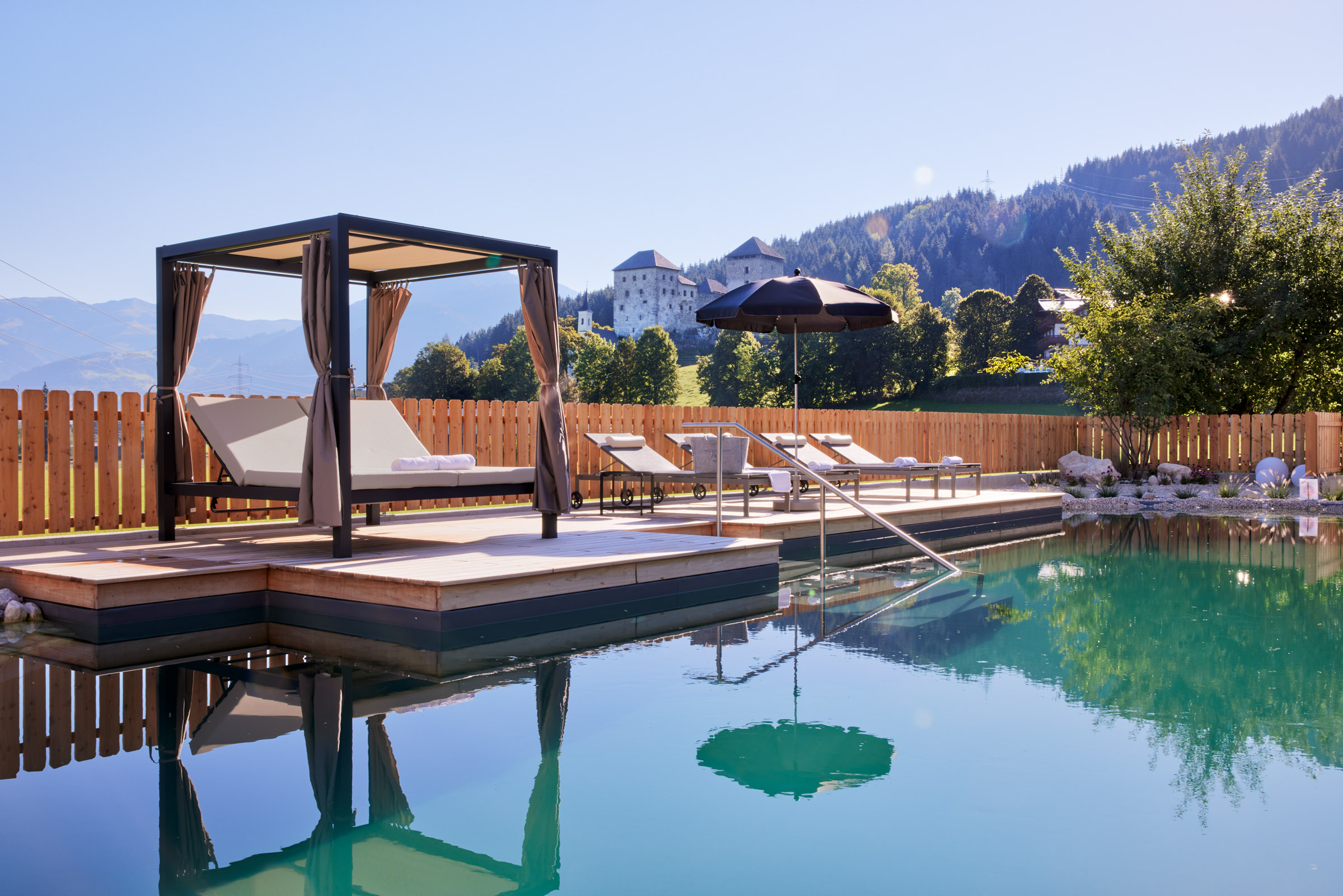 Destination-Wedding: Der Garten mit Natur-Schwimmteich und Blick auf die Burg Kaprun. - SOULSISTERS'